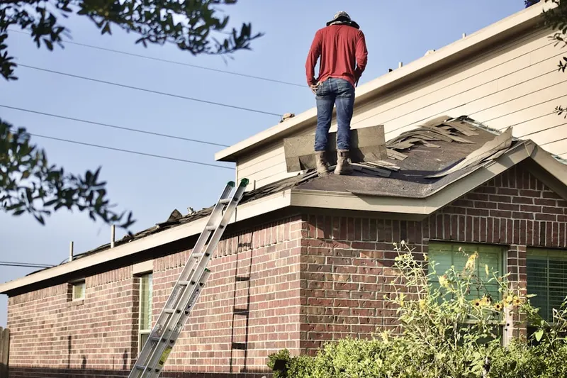 Professional roofer working on a residential roof in Woodcrest Acres